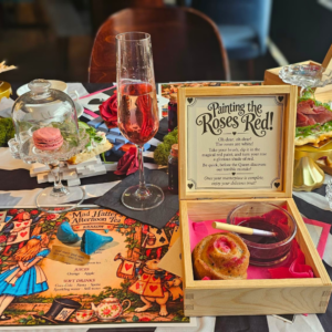 Mad Hatter's Afternoon Tea in Krakow, a Wonderland table with Prosecco and Eat Me treats